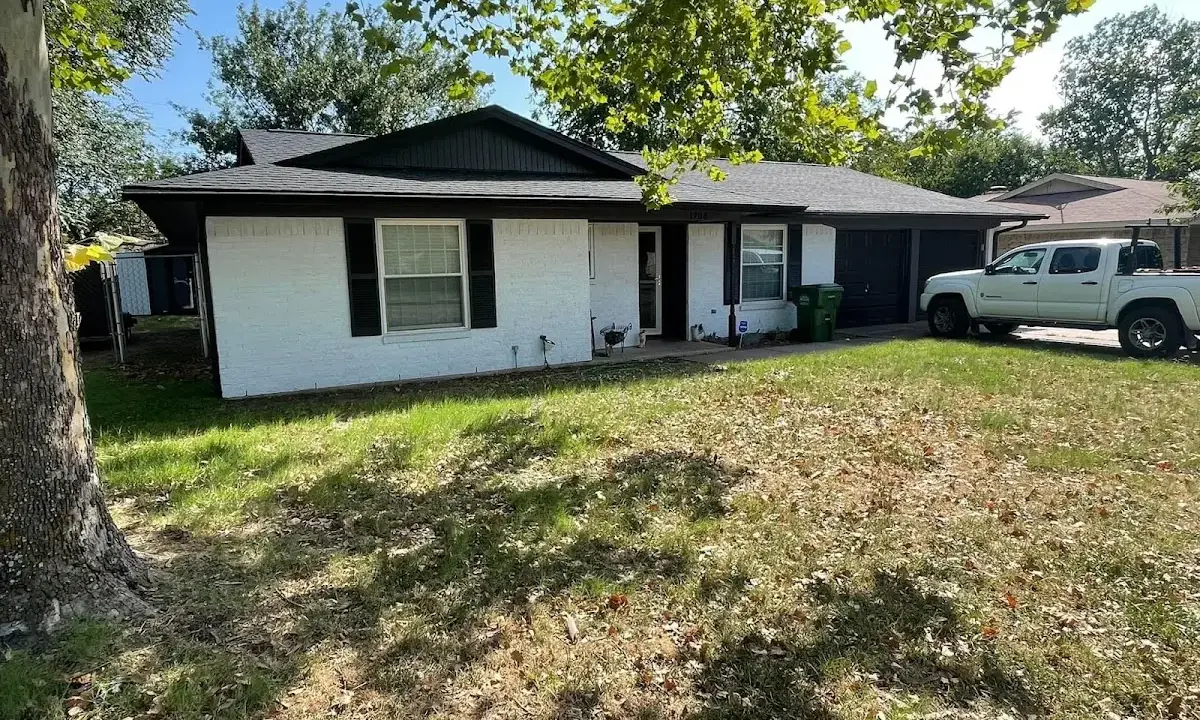 Professional roofing crew working on a residential roof in Scottsburg